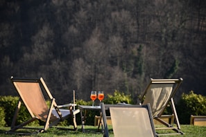 brown wooden folding chairs on green grass field during daytime