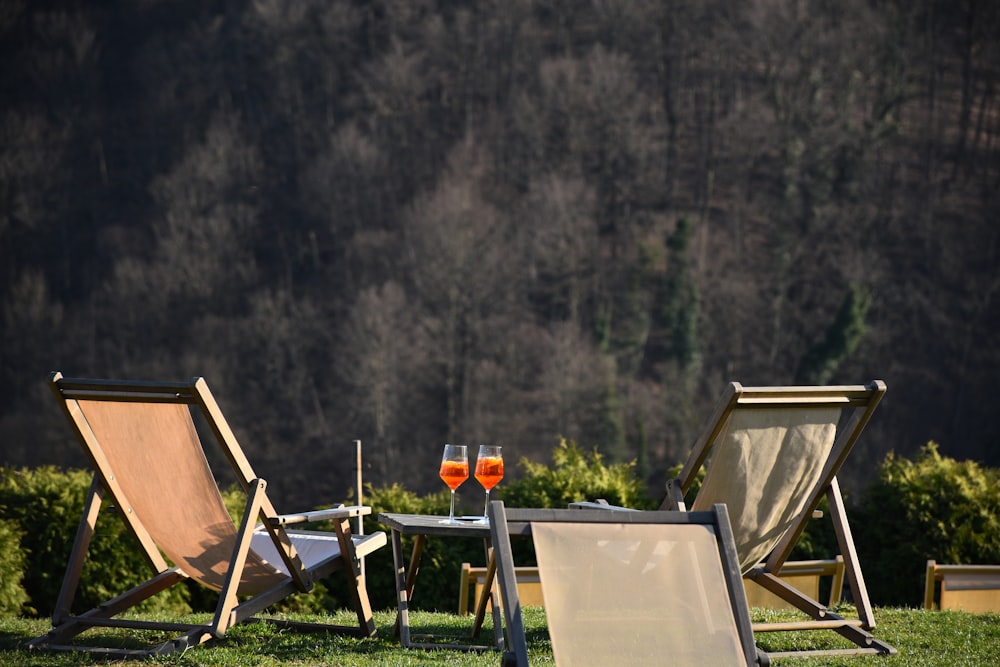 brown wooden folding chairs on green grass field during daytime