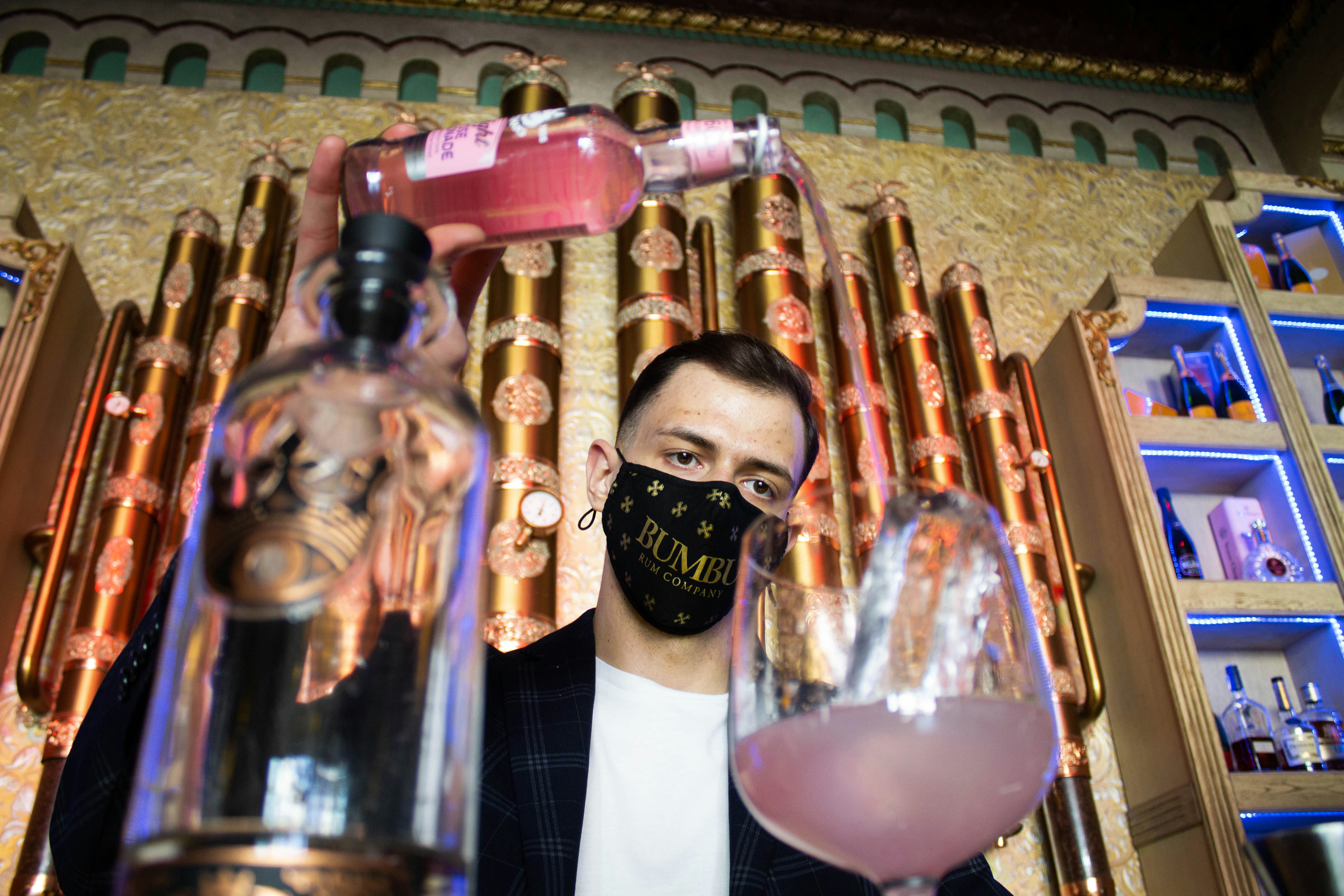 woman in black hijab holding perfume bottle, 