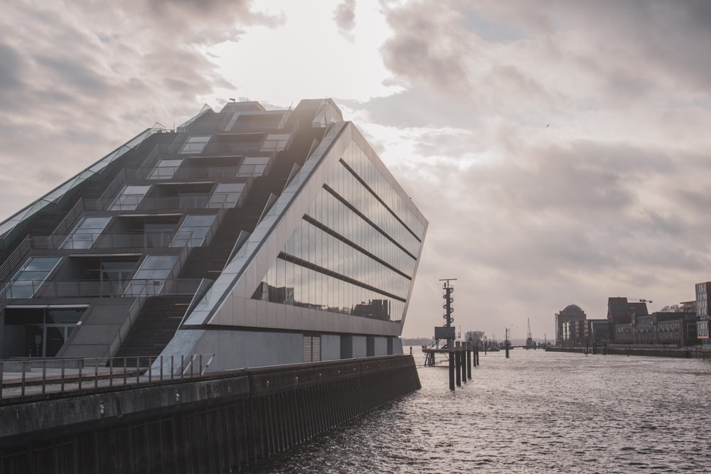 white and black concrete building near body of water during daytime