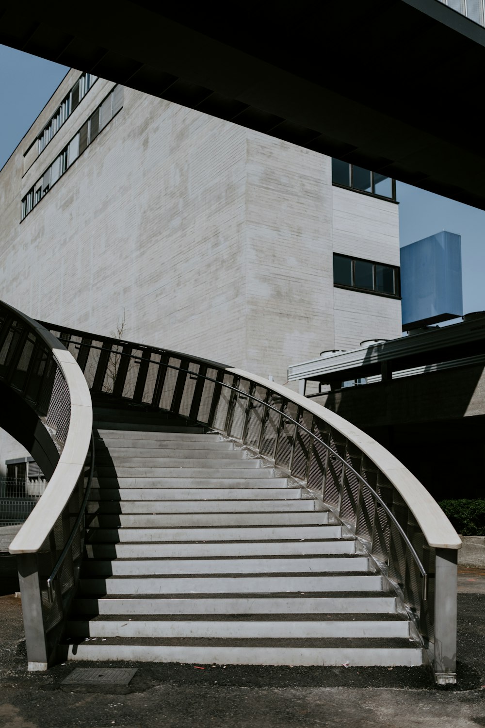 white concrete building with black metal railings