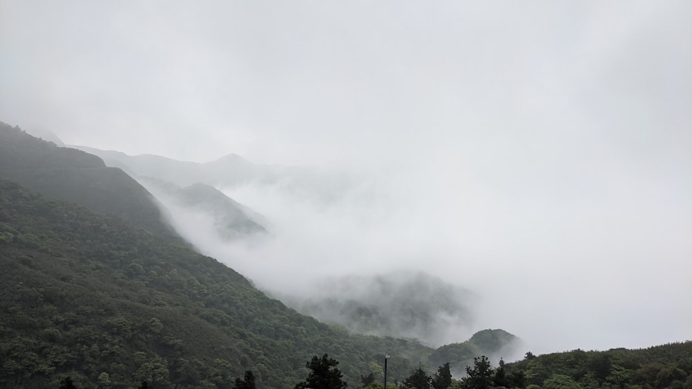 green mountain under white clouds during daytime