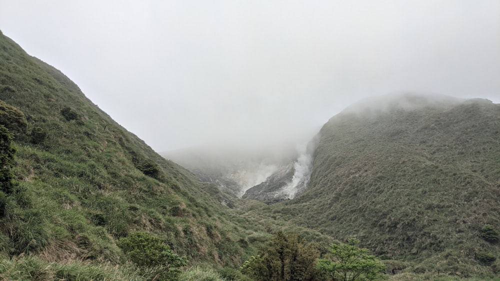 green mountain covered with fog