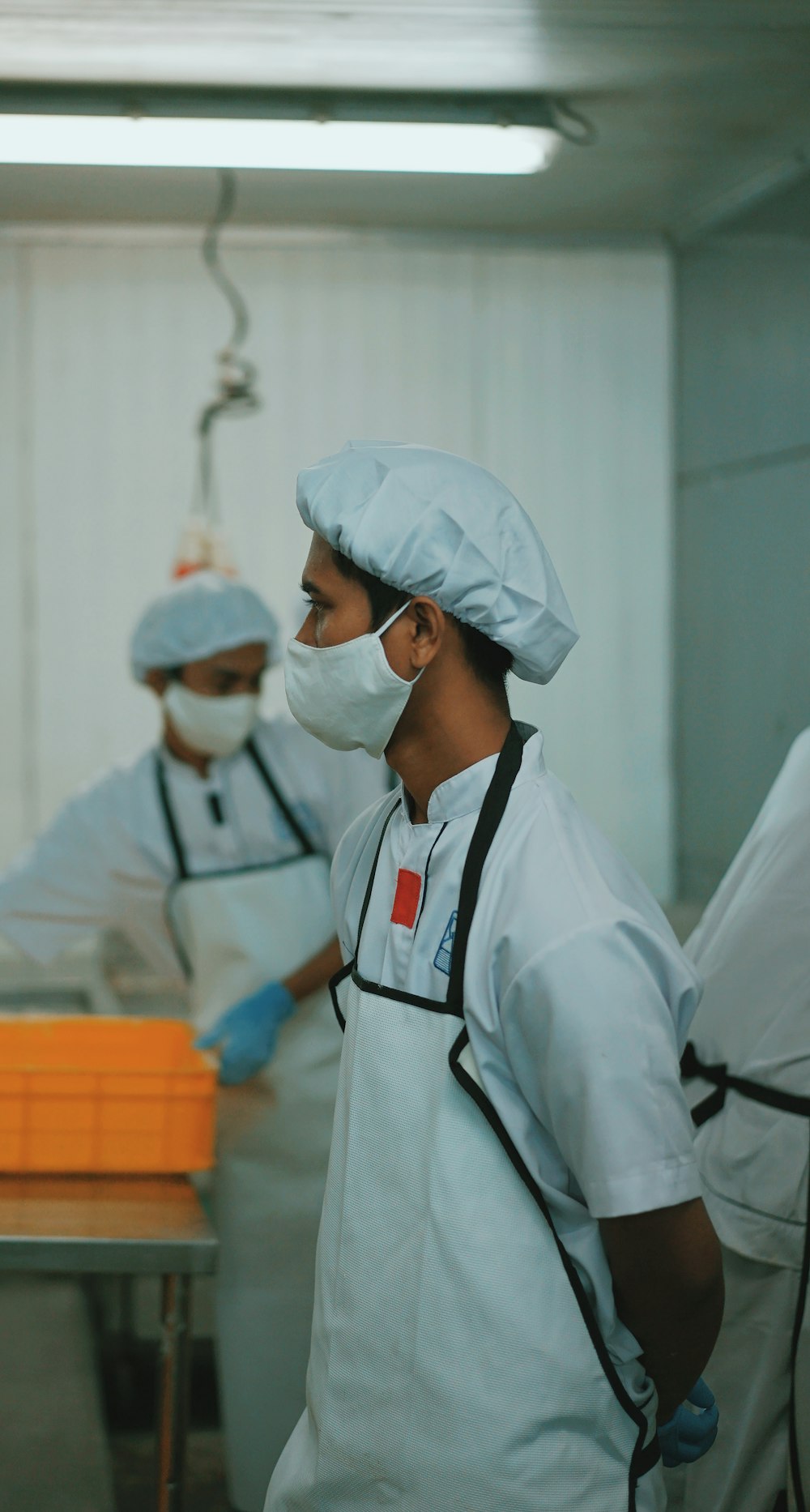 man in white medical scrub wearing white face mask