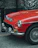 Close-up of a vintage car with a shiny identification plate attached.