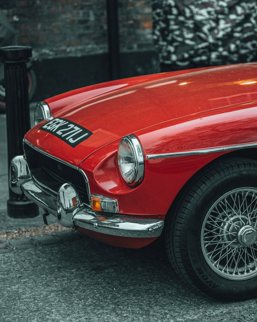 red car on gray asphalt road during daytime