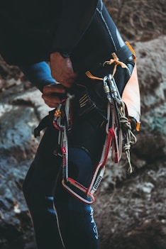 person holding black and red leather backpack