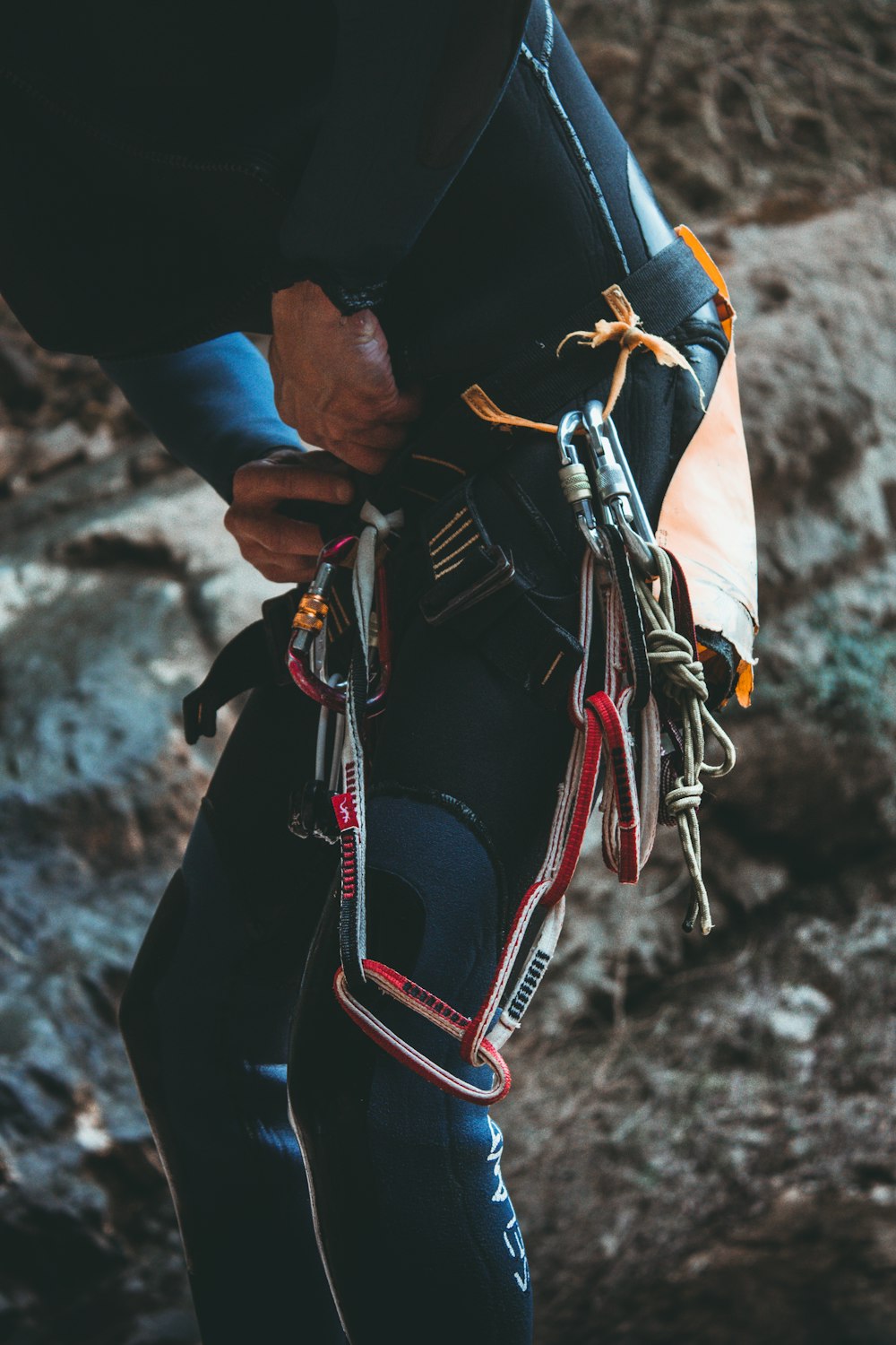 person holding black and red leather backpack