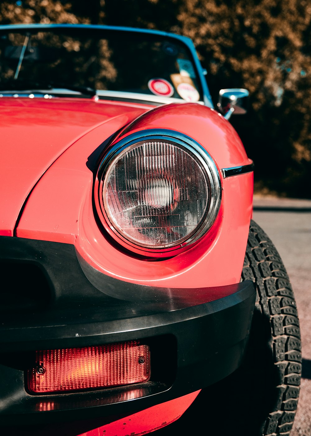 red car on black asphalt road during daytime