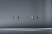 The image consists of the word 'MINIMAL' in a modern, sleek font. The background is a smooth gradient of gray shades, which emphasizes the simplicity and elegance of the design.
