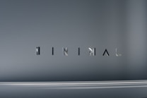 The image consists of the word 'MINIMAL' in a modern, sleek font. The background is a smooth gradient of gray shades, which emphasizes the simplicity and elegance of the design.