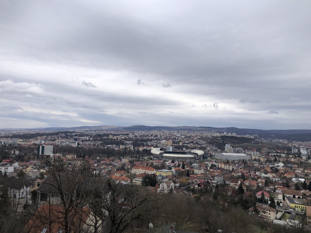 city with high rise buildings under white clouds during daytime