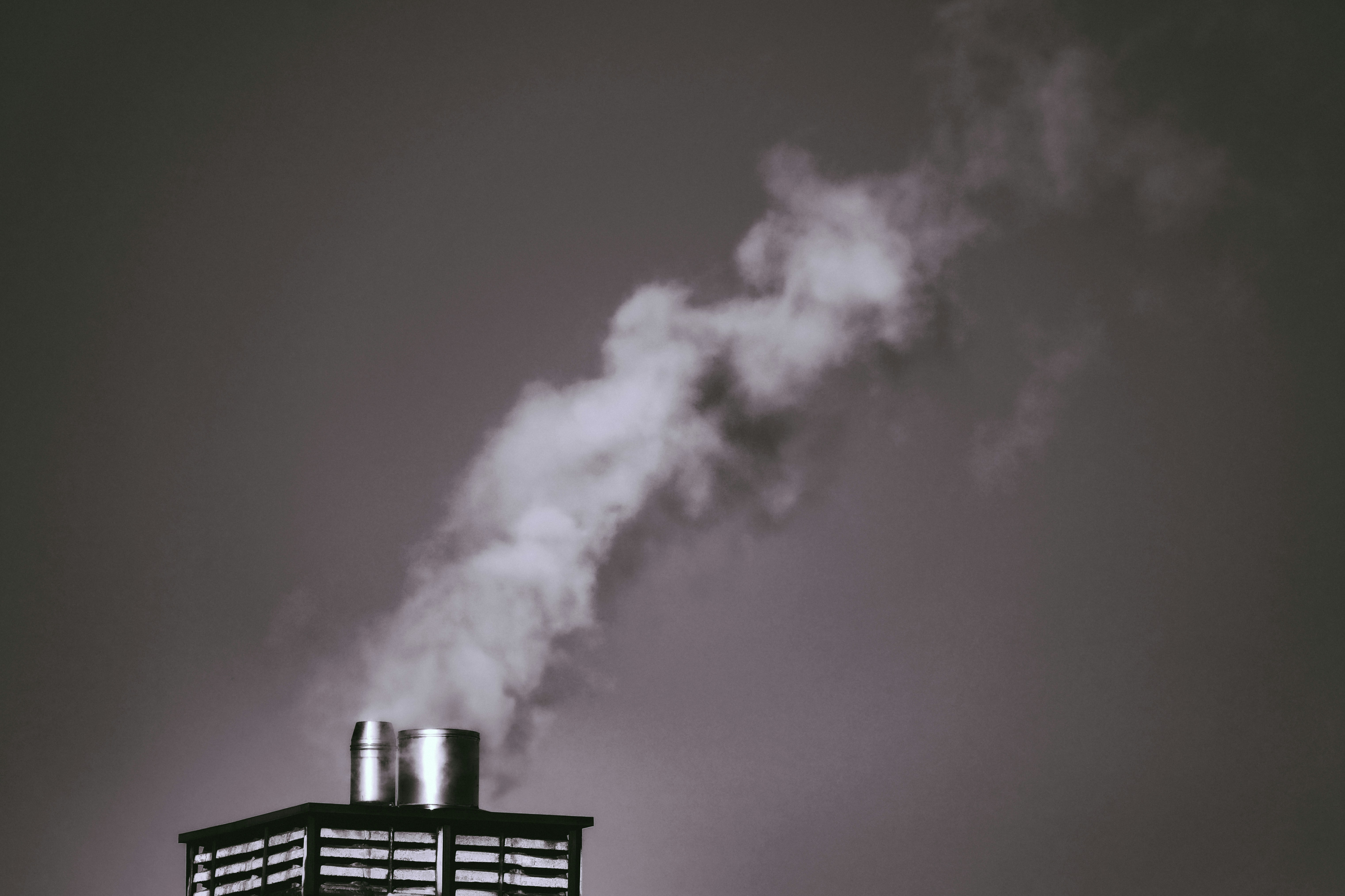 white smoke coming out from a black metal gate