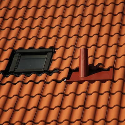 black rectangular device on brown roof