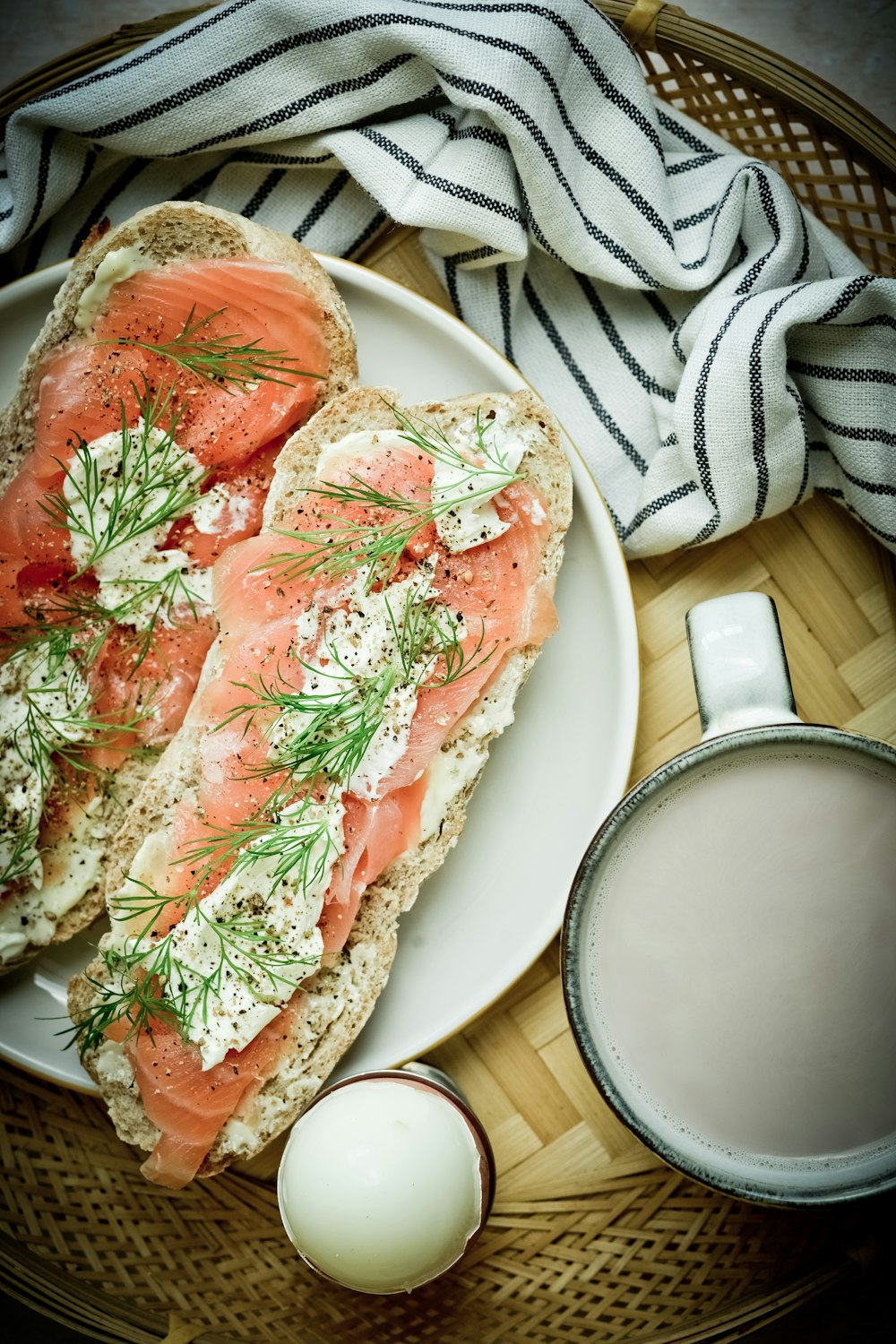 sliced bread with tomato and cheese on white ceramic plate