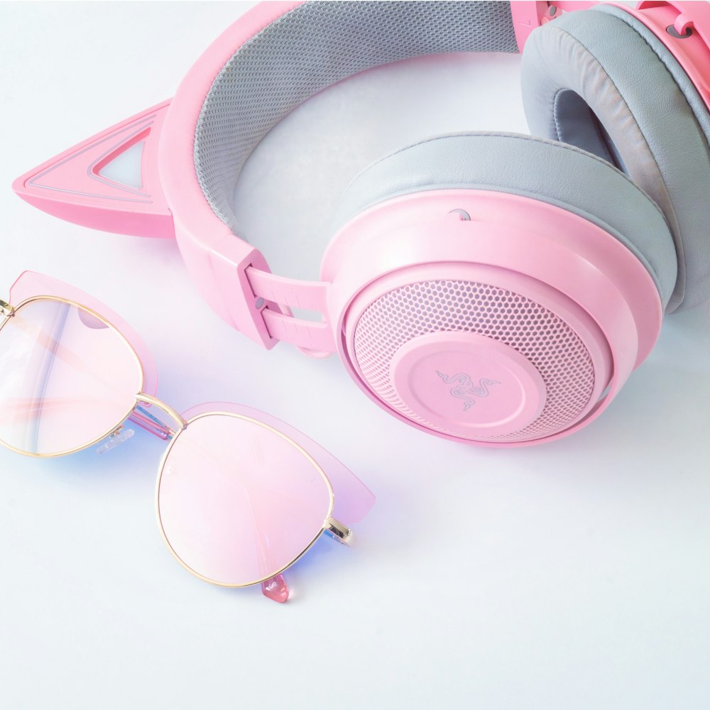 pink and white headphones on white table