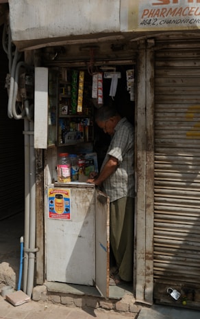 A local shopkeeper displaying goods in their shop.
