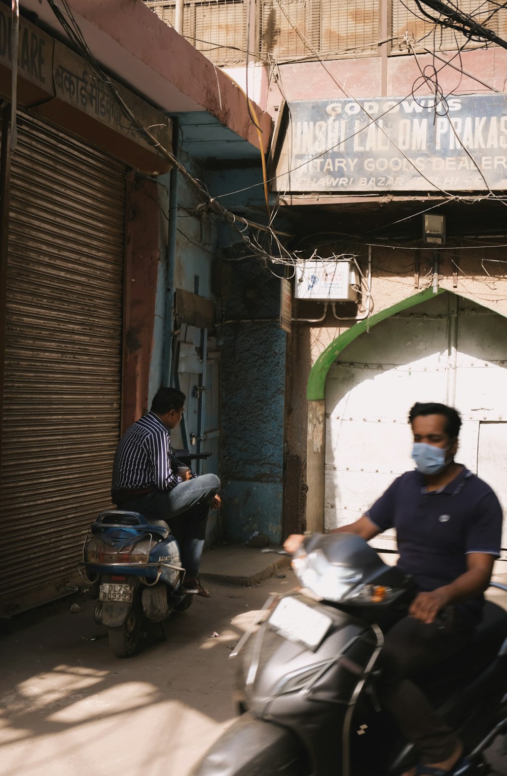 man in blue polo shirt sitting on motorcycle