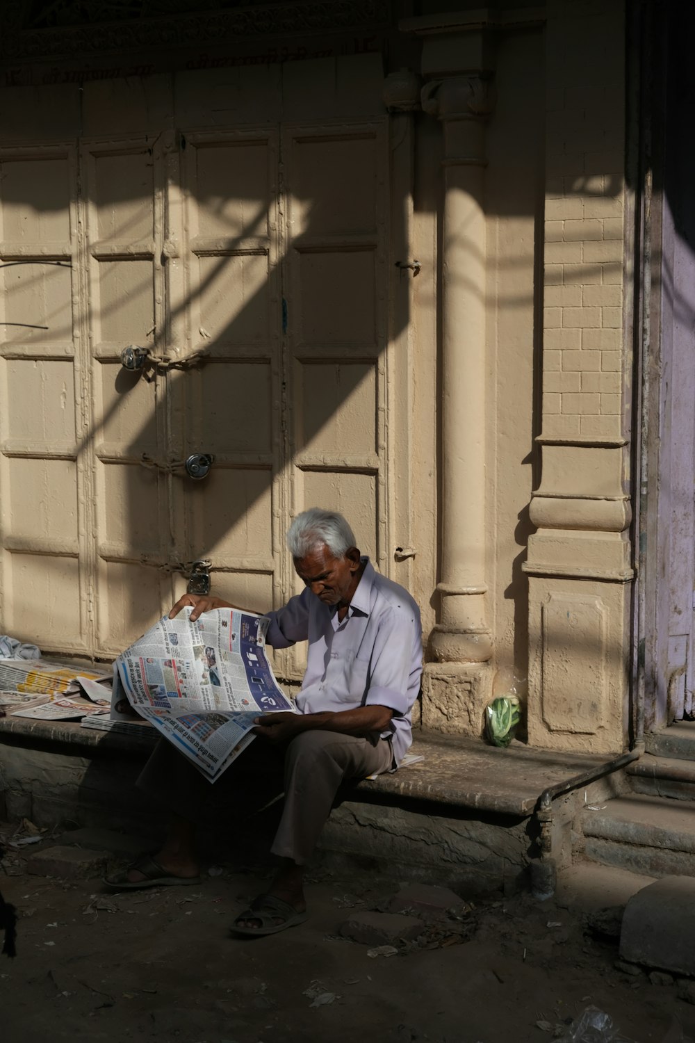 man in white dress shirt reading book