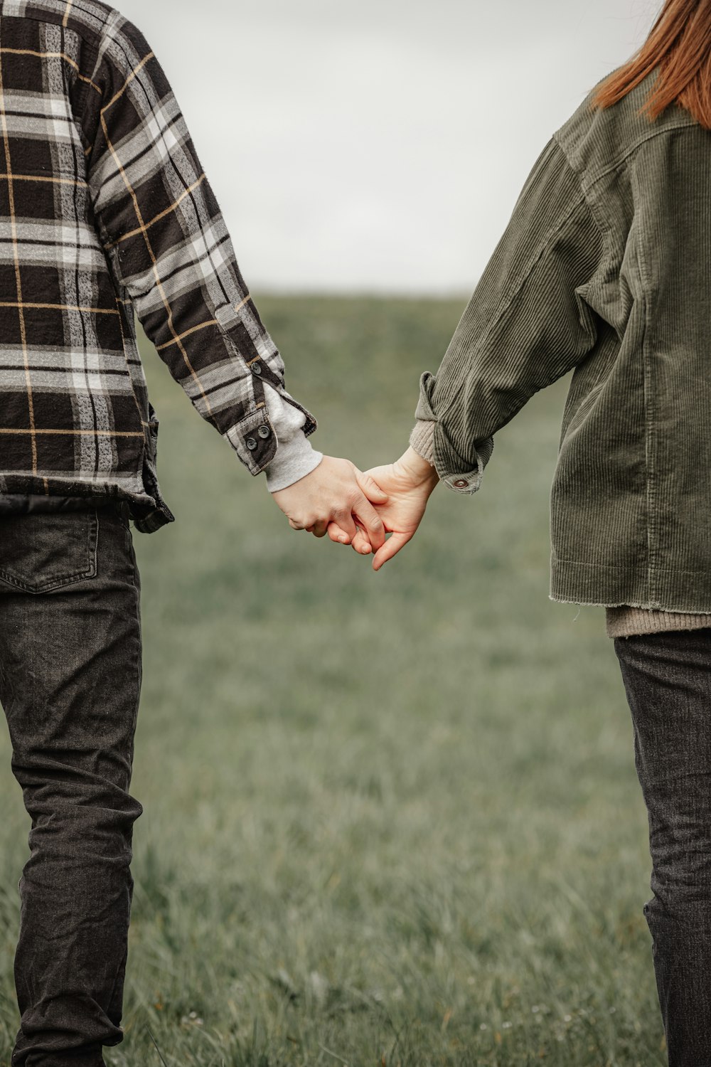 man in black and white plaid dress shirt and gray pants holding hands with woman in in on on on