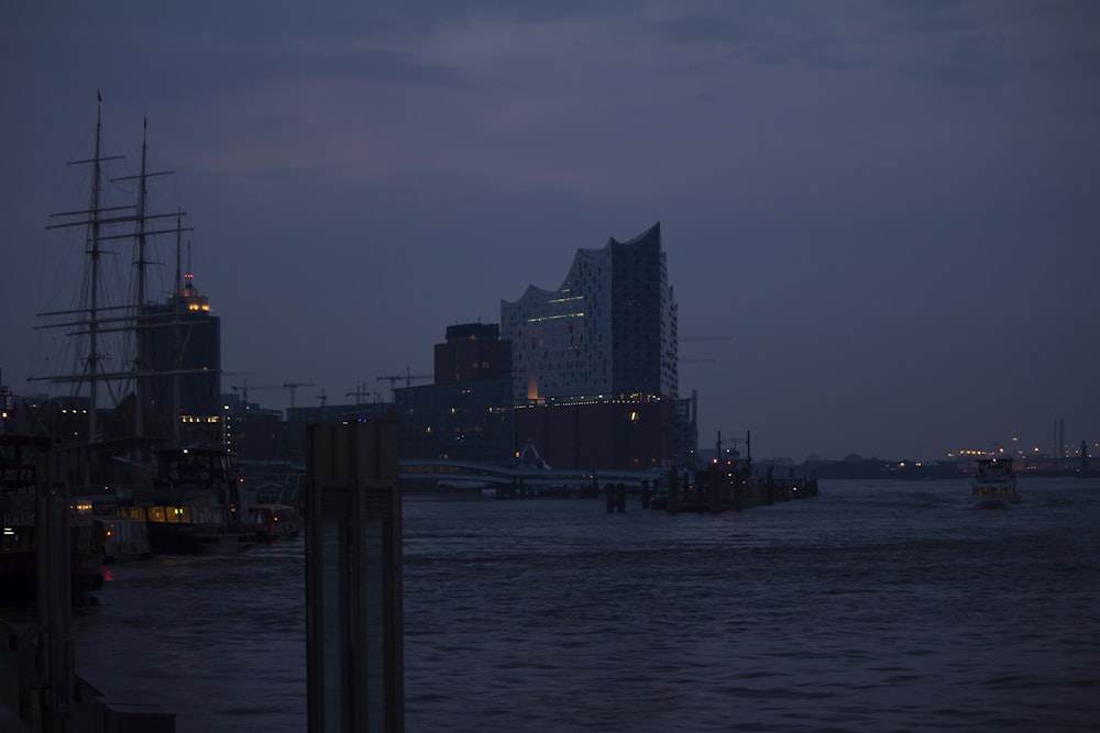 city skyline across body of water during night time