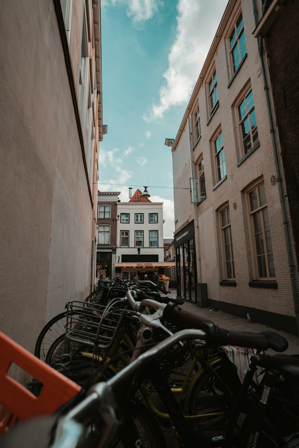 black motorcycle parked beside brown concrete building during daytime