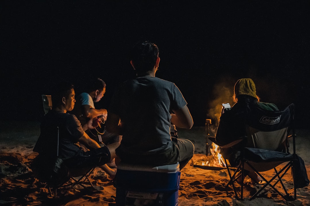 group of people sitting on ground during nighttime