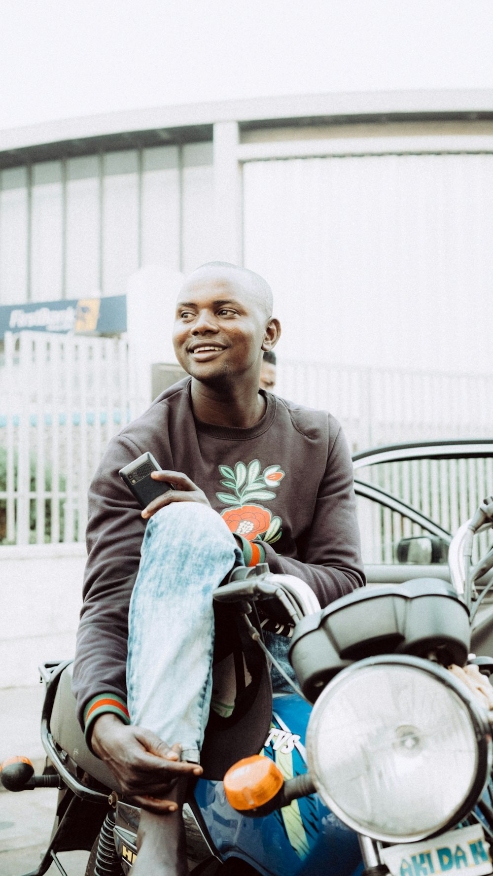 man in gray crew neck long sleeve shirt sitting on red motorcycle