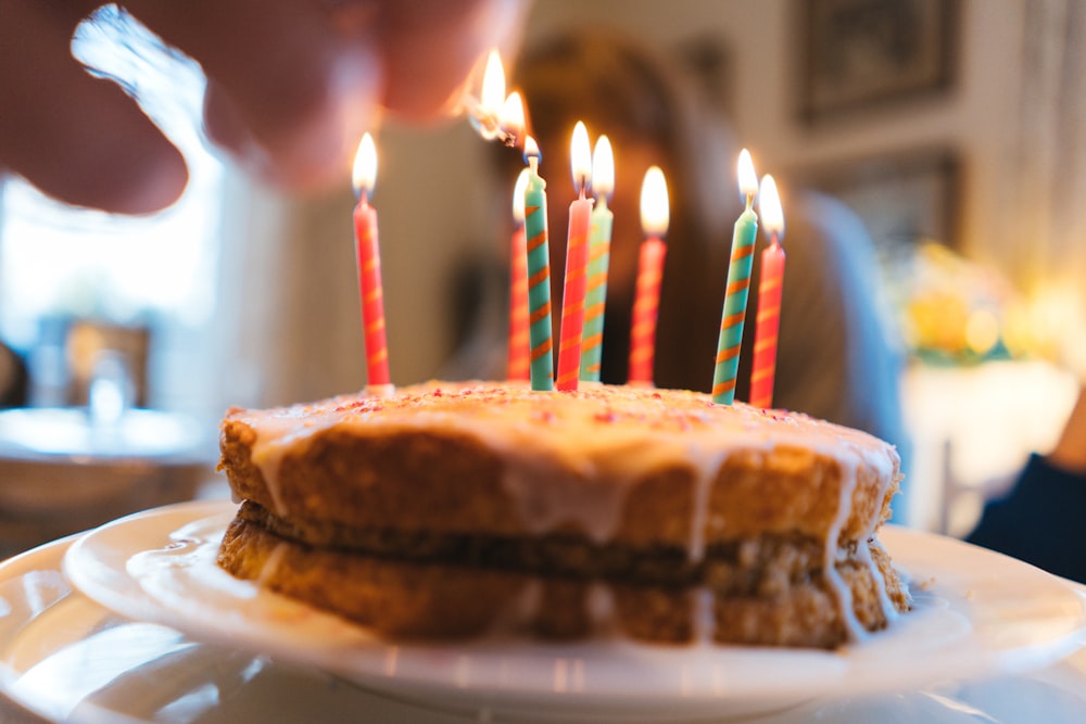 cake with candles on white ceramic plate