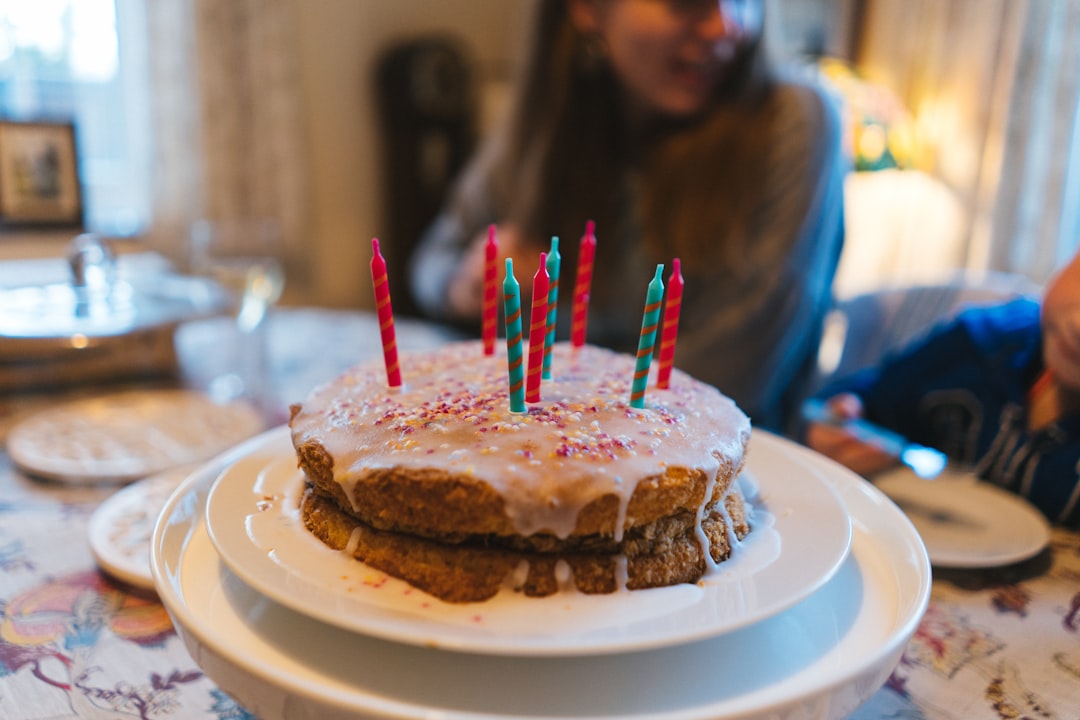 chocolate cake with red candles on white round plate