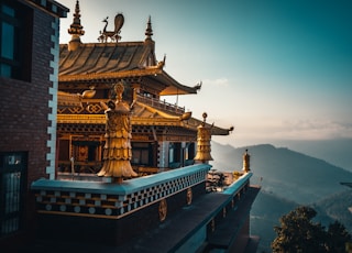 brown and green temple on top of mountain during daytime