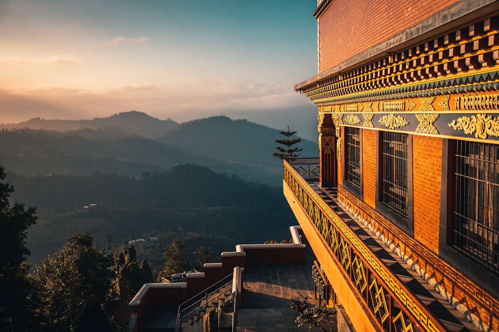 a view of a building with mountains in the background