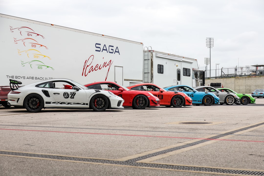 red and blue sports car on road during daytime