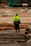 Close-up of a worker wearing a bright yellow reflective vest on a construction site.