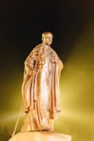 A serene statue of Hermes Trismegistus surrounded by glowing symbols.