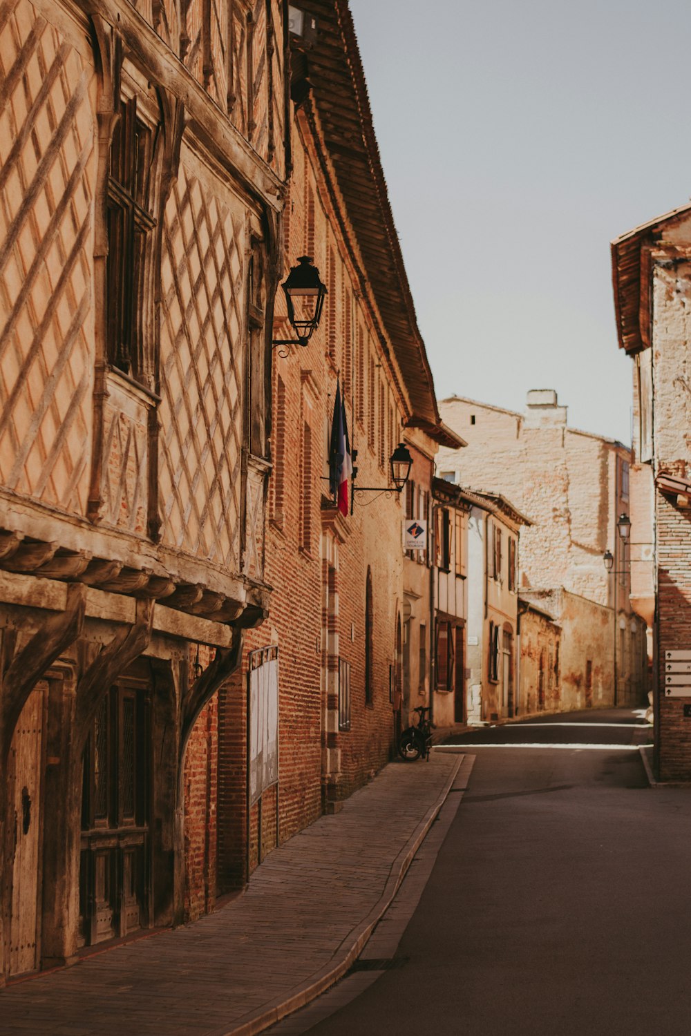 brown brick building beside road during daytime