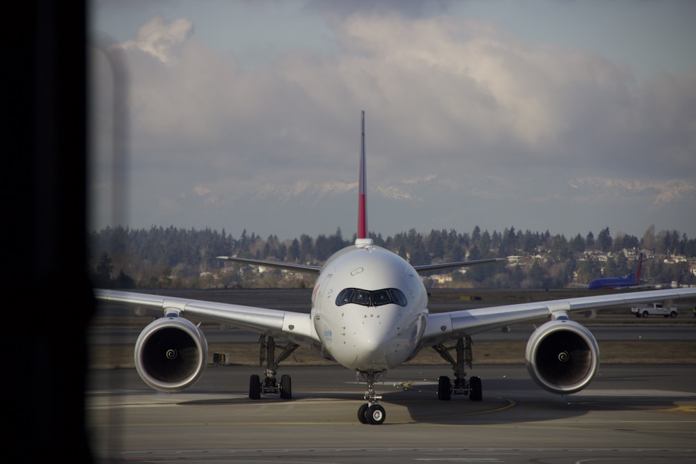 white passenger plane on airport during daytime