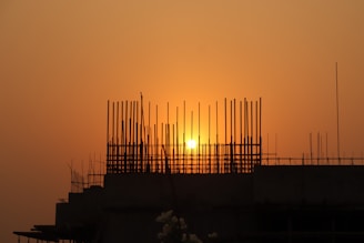 silhouette of people standing on building during sunset