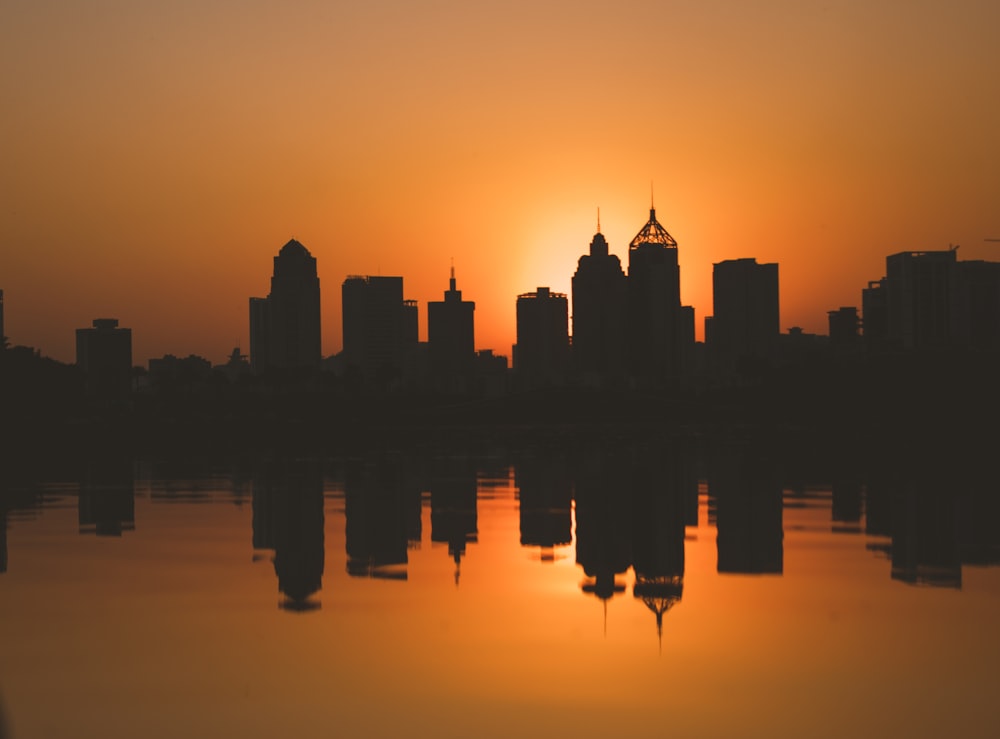 silhouette of city buildings during sunset