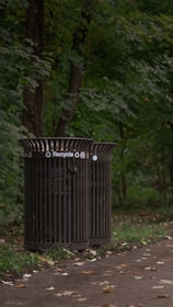 A vibrant recycling bin filled with various recyclable materials in a lush green park.