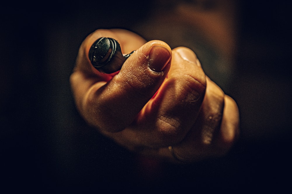 person holding silver round ornament