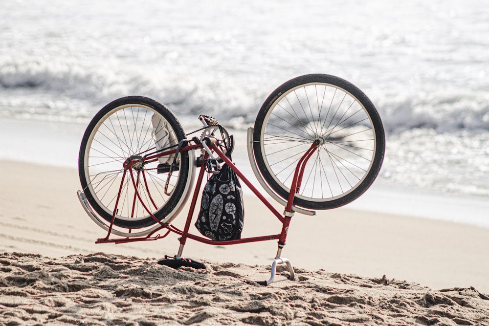 black and white bicycle on brown sand during daytime