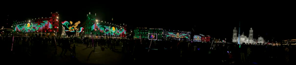 A panoramic view of Pamplona’s historic streets filled with festival-goers in the evening light.