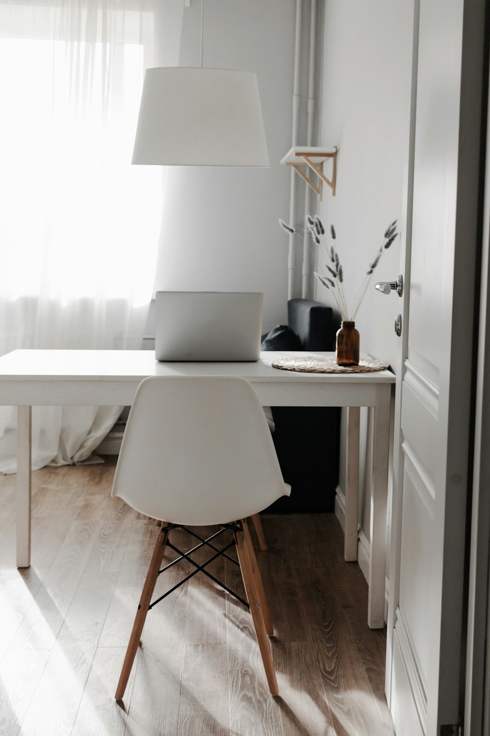 silver macbook on white wooden table