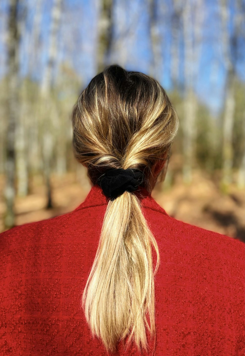 woman in red shirt with blonde hair