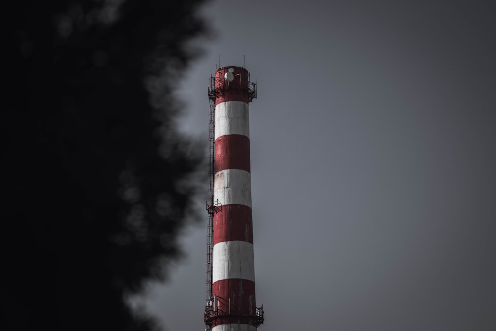 red and white tower under cloudy sky