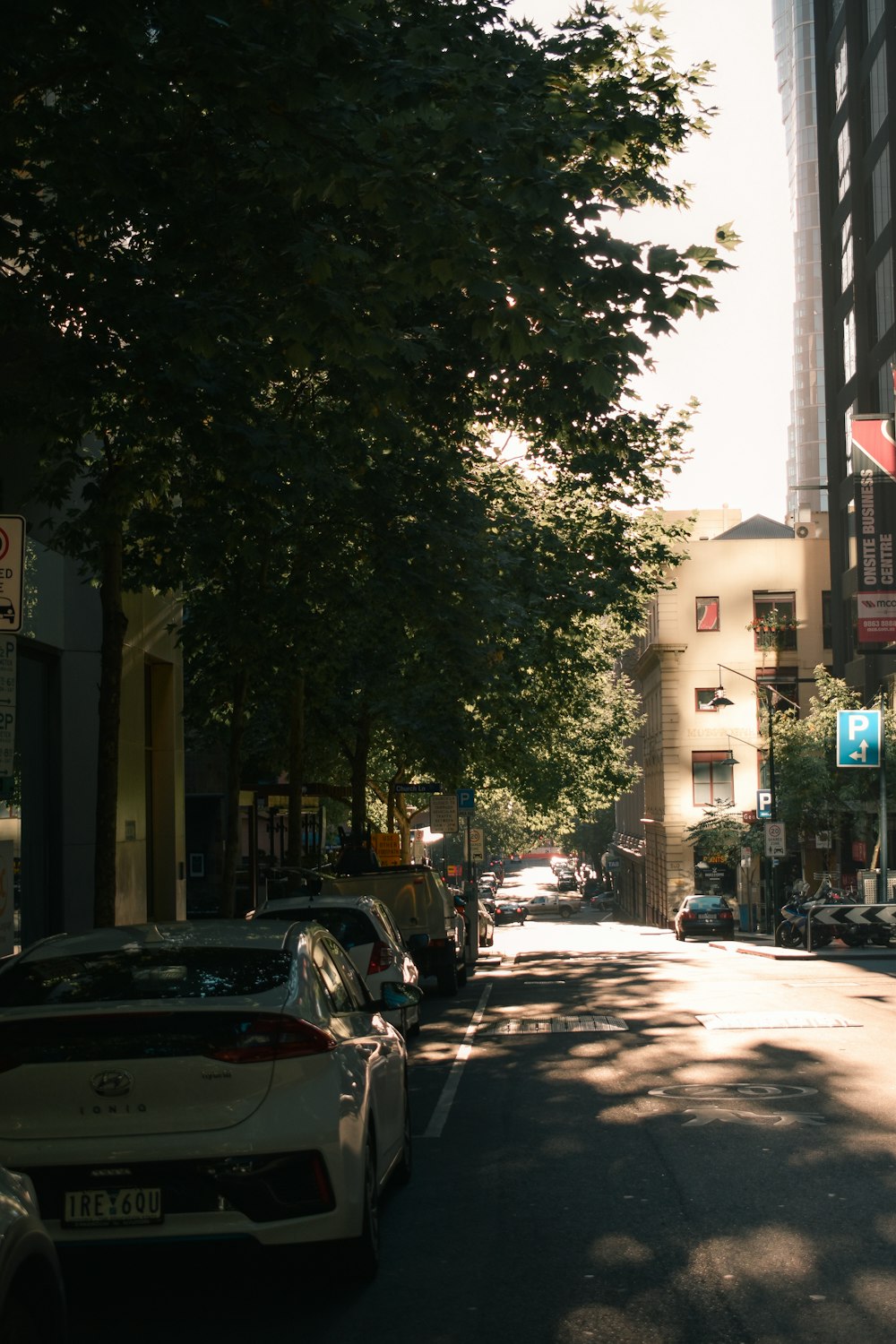 cars parked on side of the road during daytime