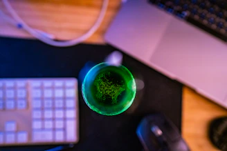 Close-up of a synergia multimedia device glowing softly on a wooden desk.