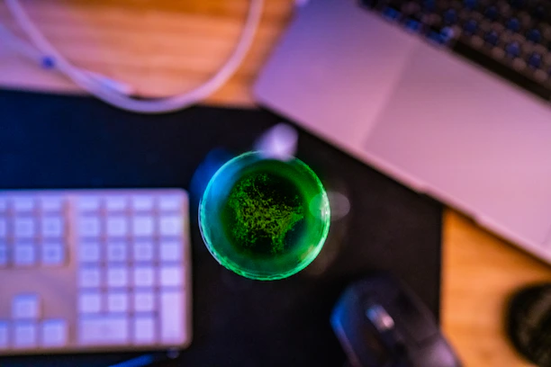 Close-up of a synergia multimedia device glowing softly on a wooden desk.