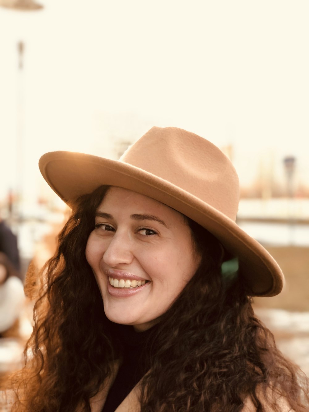 smiling woman wearing brown hat